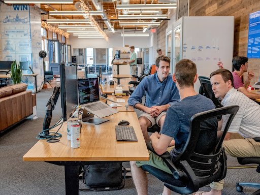 Three people sitting at a desk